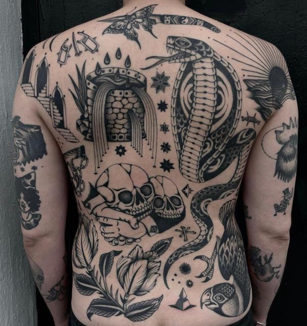 Black and white traditional back tattoo with cobra and skull