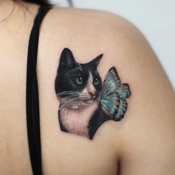 Black cat and blue butterfly shoulder bade tattoo