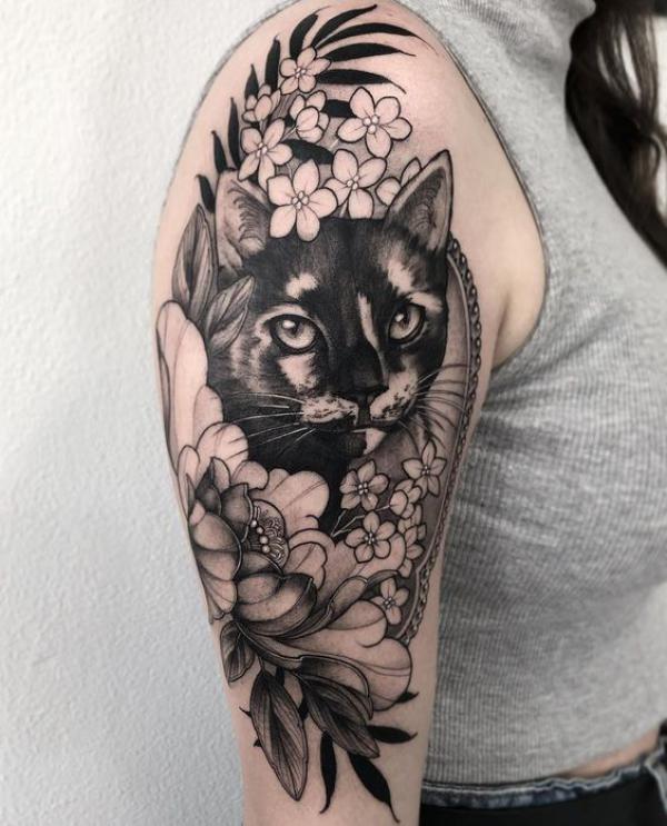 Black cat and flowers half sleeve tattoo