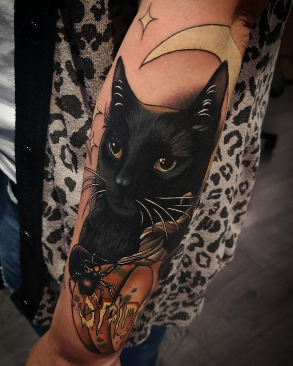 Black cat and pumpkin tattoo with moon and stars