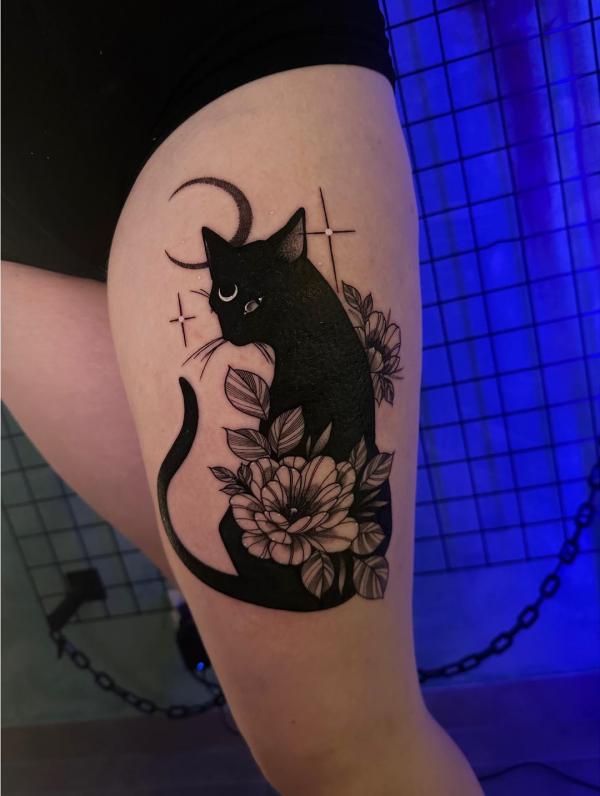 Black cat thigh tattoo