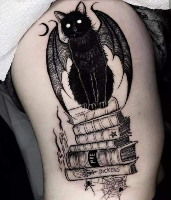 Black cat with bat wings on books