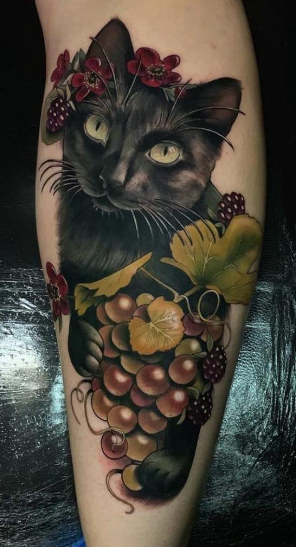 Black cat with grapes and berries