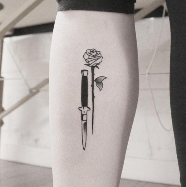 Black ink knife and rose tattoo