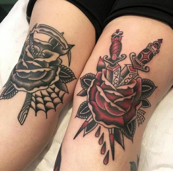 Black rose with a scythe and red rose with daggers knee tattoos