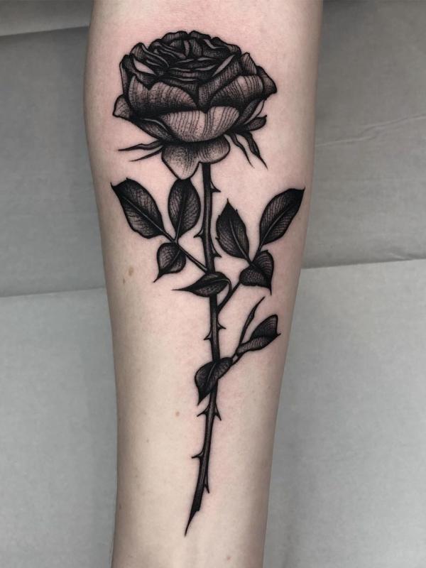 Black rose with thorns tattoo