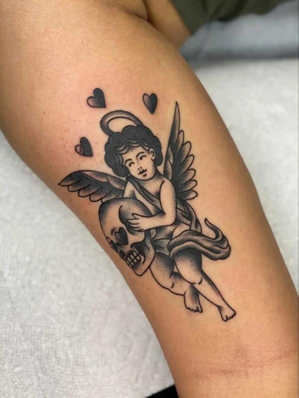 Blackwork cherub and skull tattoo