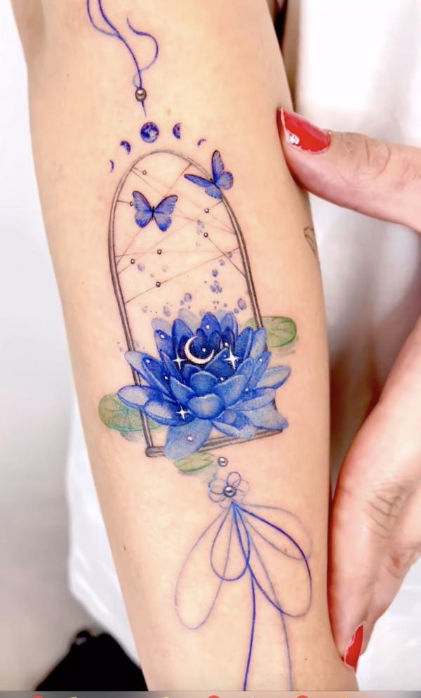 Blue butterfly and lotus with crescent moon and stars tattoo