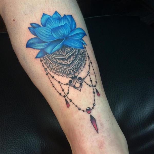 Blue lotus and bracelet tattoo