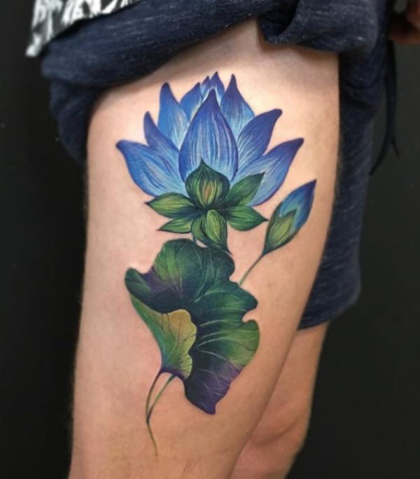 Blue lotus and green leaf tattoo