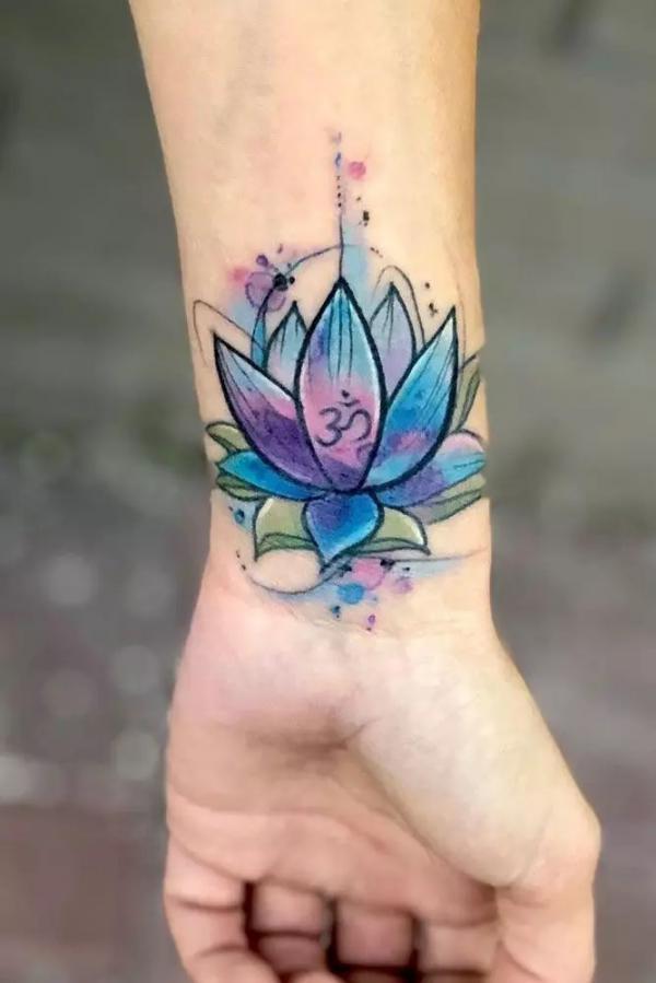 Blue lotus with OM symbol wrist tattoo