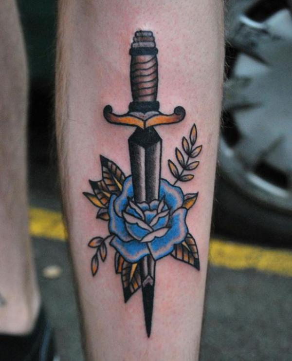 Blue rose and dagger forearm tattoo