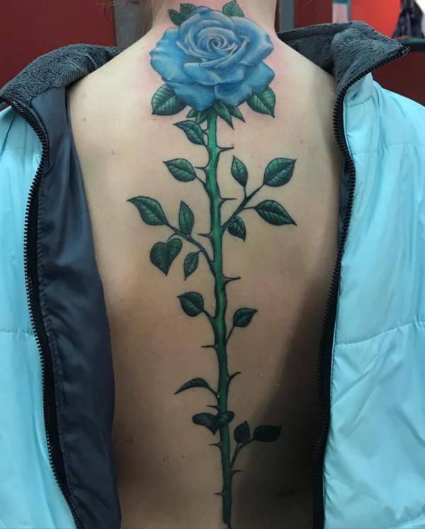 Blue rose with thorns spine tattoo