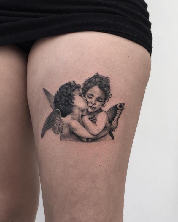 Boy and girl cherub thigh tattoo