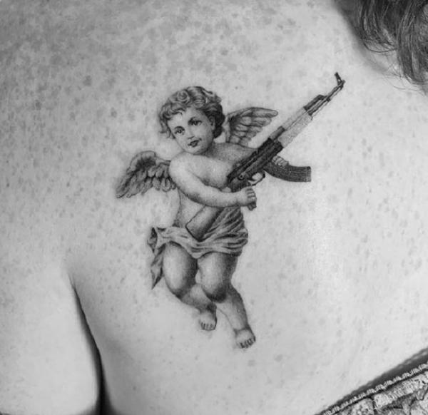 Cherub and gun back tattoo