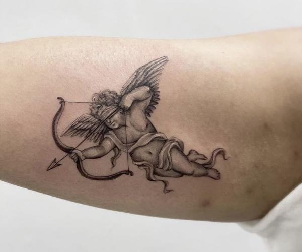 Cherub archery bicep tattoo
