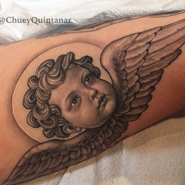 Cherub face with wings and moon tattoo