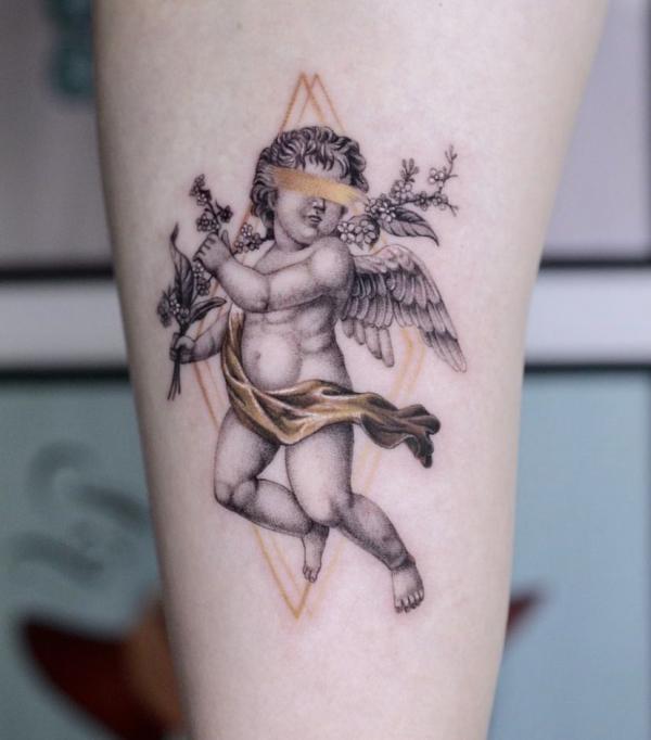 Cherub holding flower tattoo