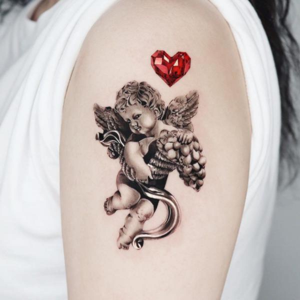 Cherub holding fruits with a heart diamond tattoo