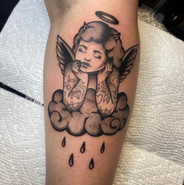 Cherub on the raining cloud tattoo