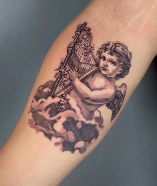 Cherub playing harp on cloud