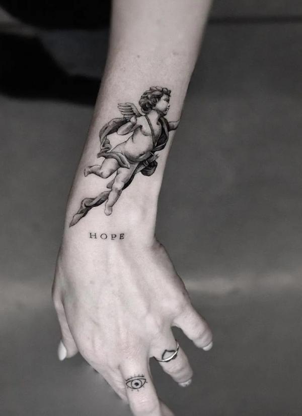 Cherub wrist tattoo