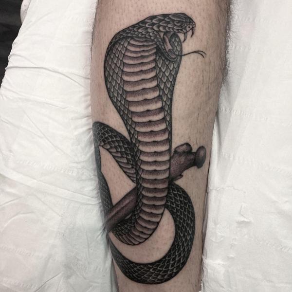 Cobra and bone tattoo