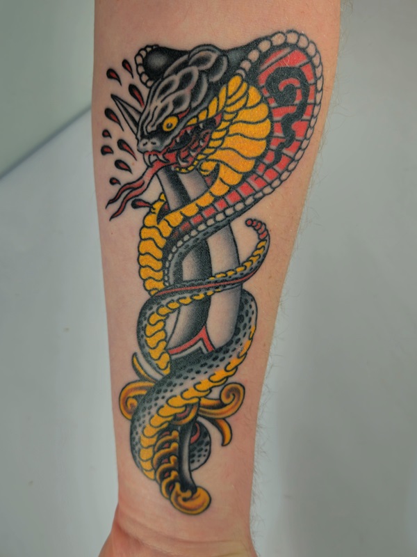 Cobra and dagger forearm tattoo