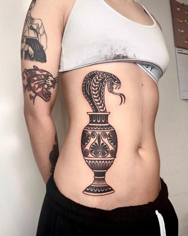 Cobra in vase side tattoo