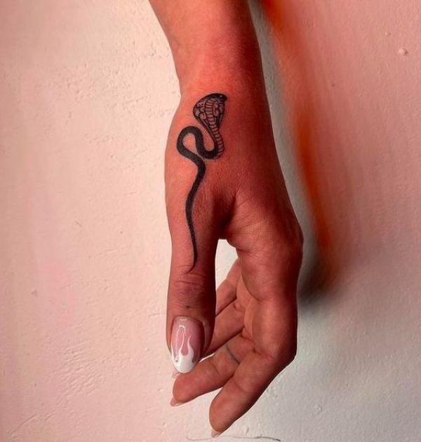 Cobra thumb tattoo