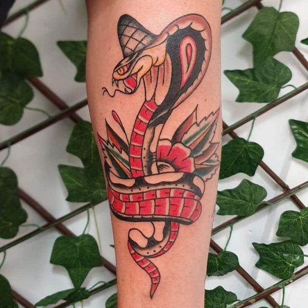 Cobra wrapping around flower tattoo