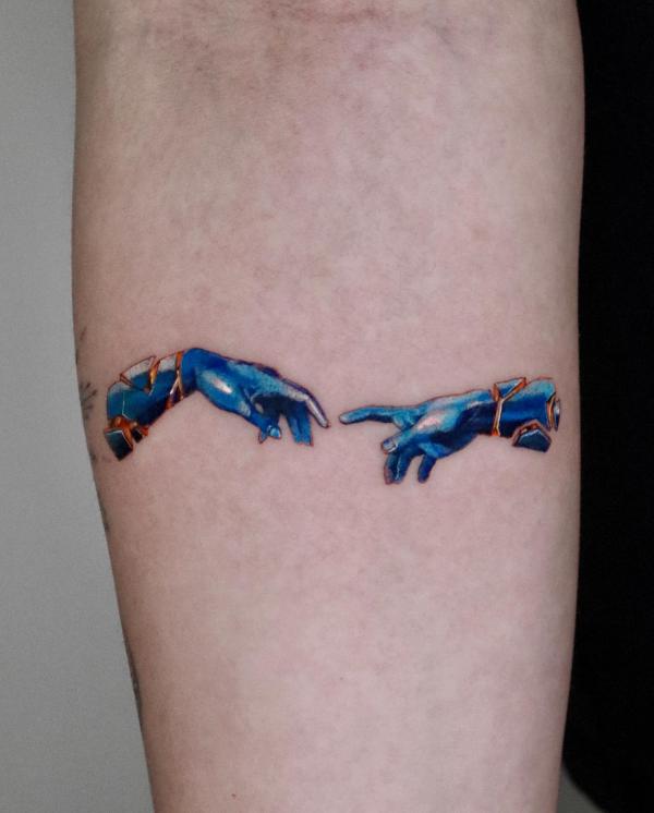 Cracked Adam hands tattoo in blue color