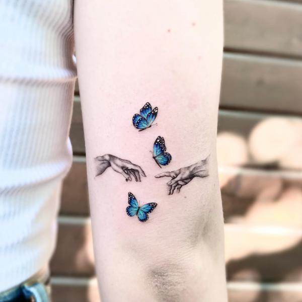 Creation of Adam With blue Butterfly tattoo