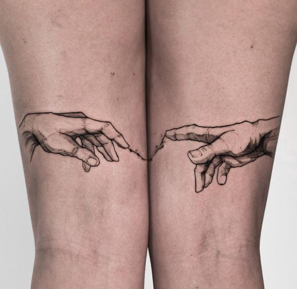 Creation of Adam hands tattoo on the back of thigh
