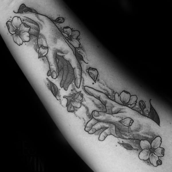 Creation of Adam with flowers tattoo black and grey