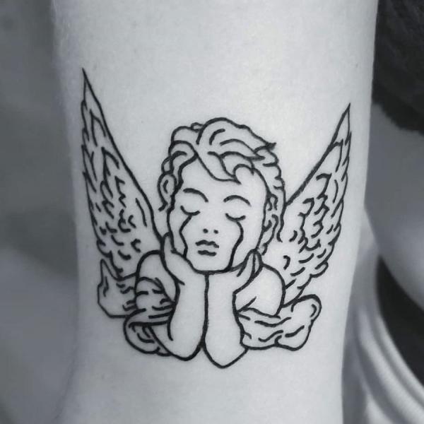 Crying cherub tattoo