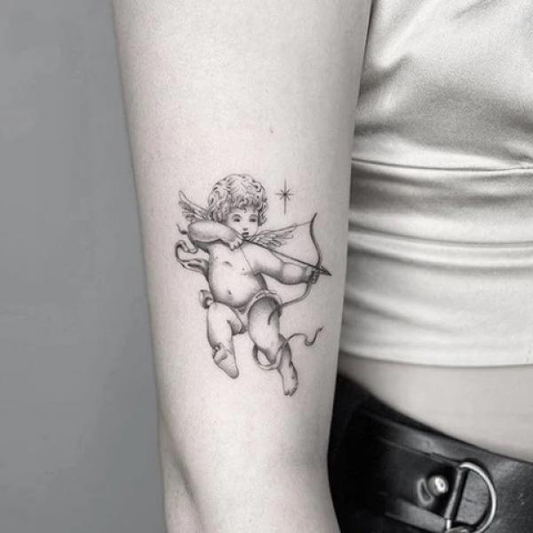 Cupid cherub shooting arrow tattoo