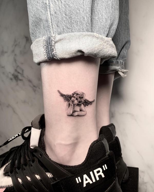 Cute Cherub tattoo above ankle