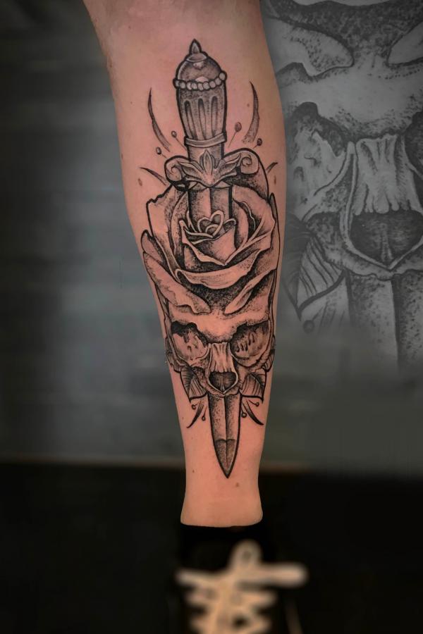 Dagger pierced rose skull tattoo black and grey