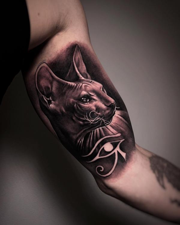 Egyptian cat and eye of Ra bicep tattoo