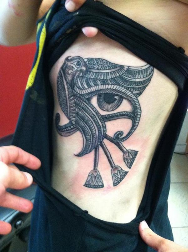 Eye of Horus with falcon tattoo
