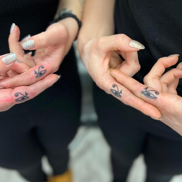 Eye of Ra Sun and Eye of horus finger tattoo