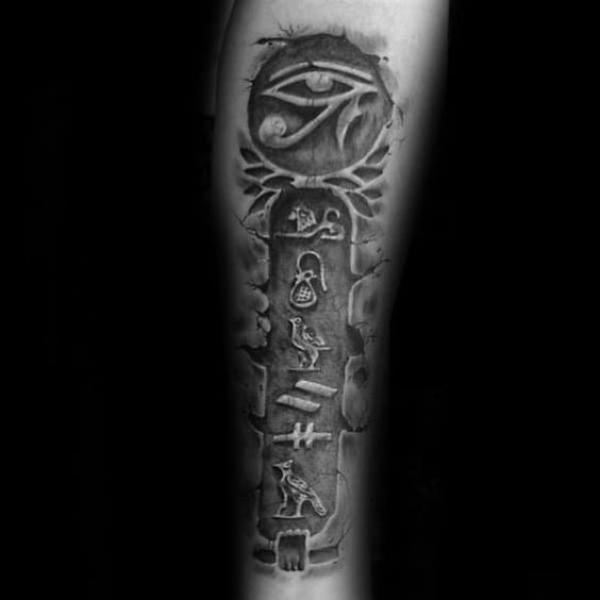 Eye of Ra and Egyptian Hieroglyphics carved in stone tattoo