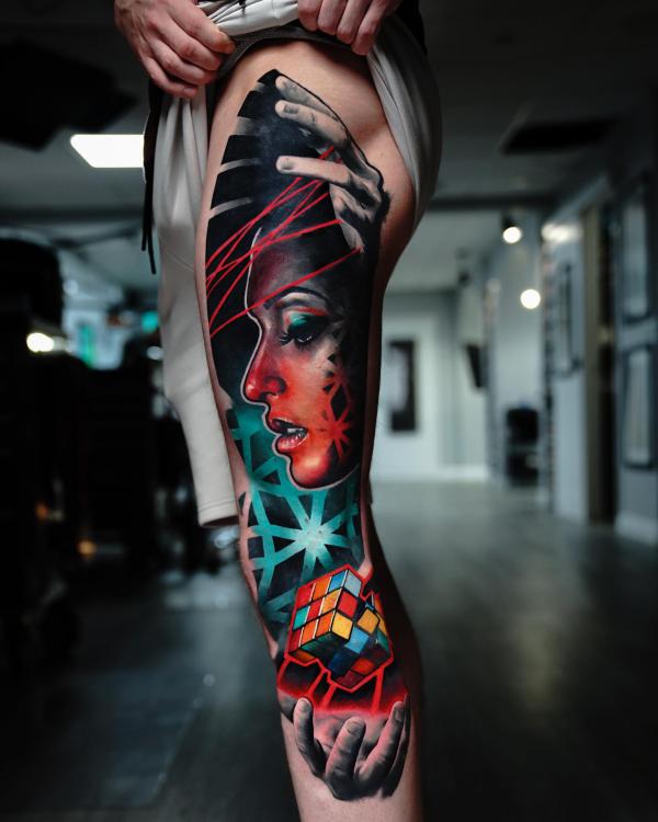 Female face and Rubiks Cube leg tattoo