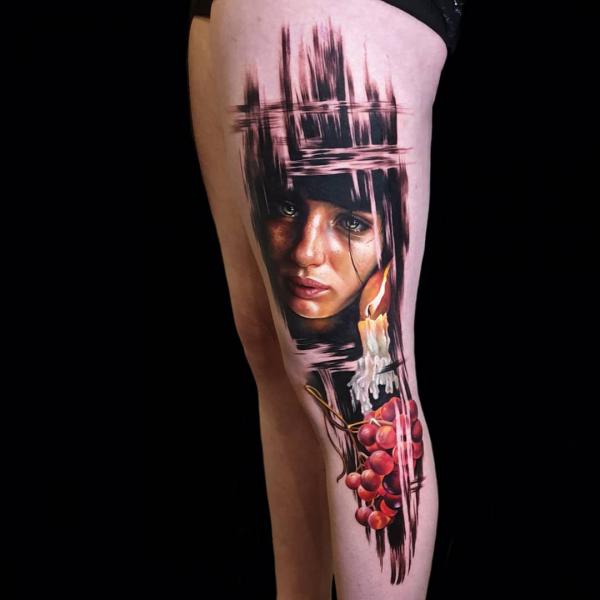 Female face and grapes with brush strokes leg tattoo