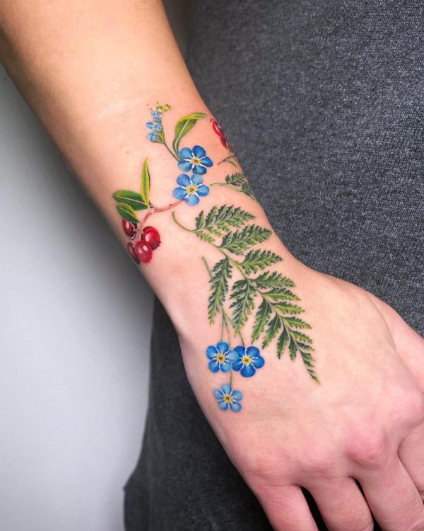 Fern and forget me not tattoo on wrist
