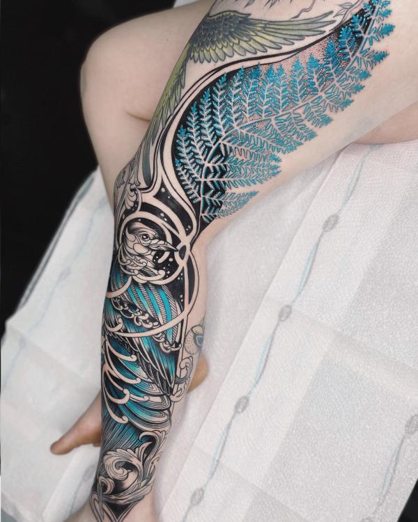 Fern and phoenix leg tattoo in Japanese style