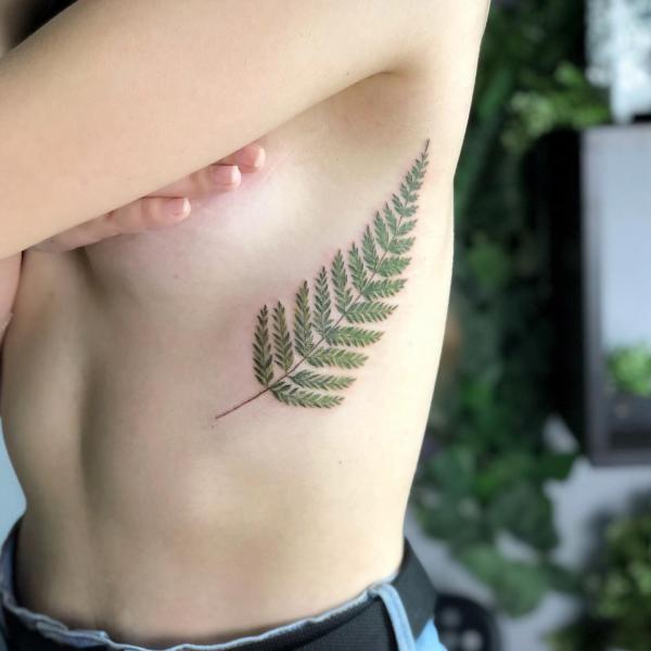 Fern side tattoo