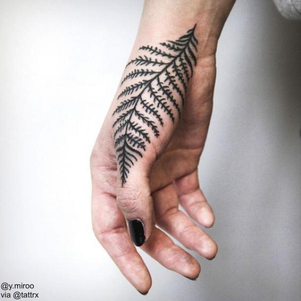 Fern thumb finger tattoo