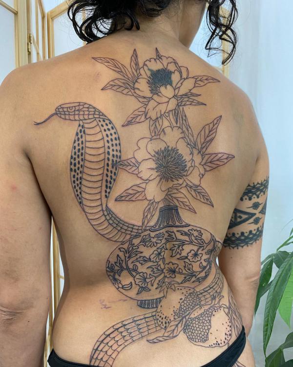 Fine line cobra and flower back tattoo